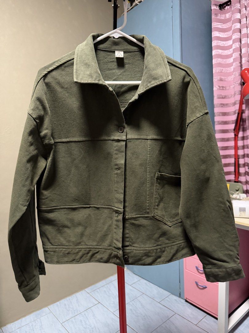 Olive Green Jacket (Category: Coats, Jackets and Outerwear) located in San Jose del Monte. Submitted by thriftream (Listing ID 1460992525, Image 1). Description: - Olive green cropped jacket - Button closure - Two front pockets - Collar detail - Estimated size: Medium - Ideal for layering.