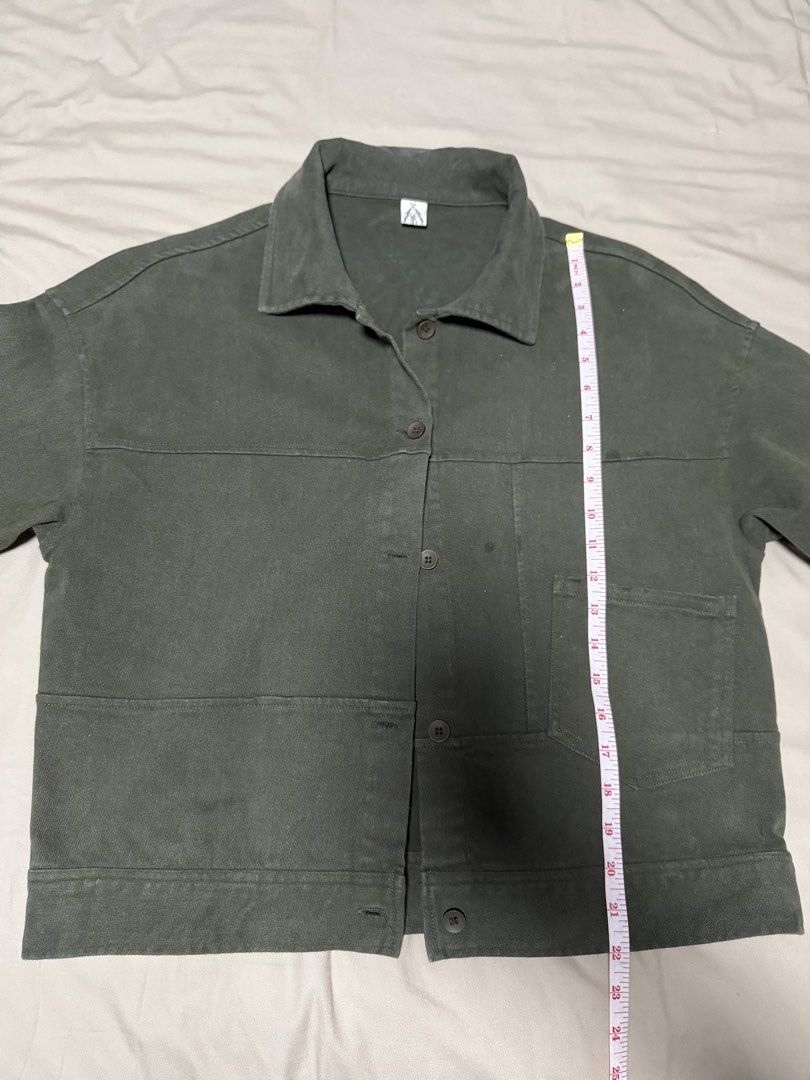 Olive Green Jacket (Category: Coats, Jackets and Outerwear) located in San Jose del Monte. Submitted by thriftream (Listing ID 1460992525, Image 2). Description: - Olive green cropped jacket - Button closure - Two front pockets - Collar detail - Estimated size: Medium - Ideal for layering.