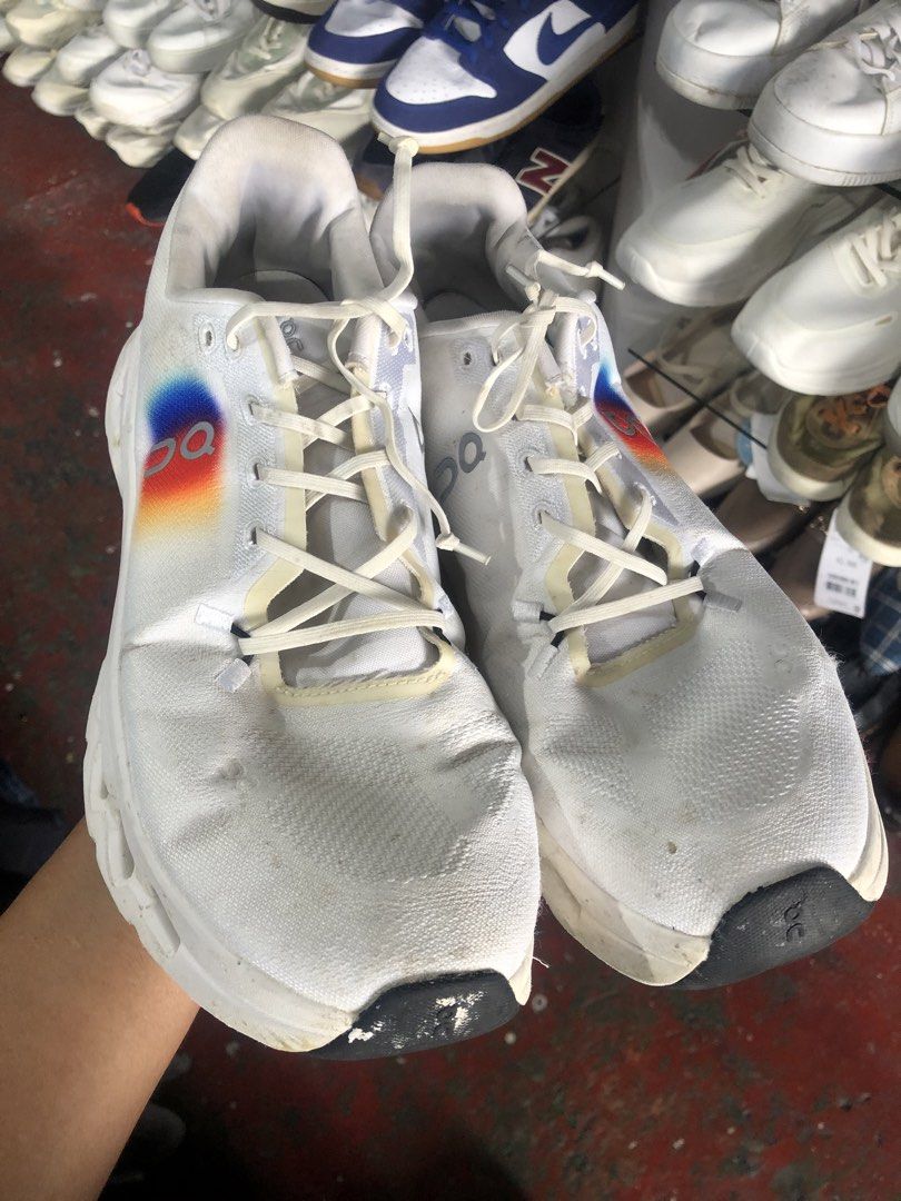 ON Cloudtilt White Running Shoes (Category: Sneakers) located in Cavite. Submitted by thriftkicks3 (Listing ID 1460993441, Image 2). Description: - ON Cloudtechphase running shoes - Color: White - Signature ON rainbow logo on the side - White laces - Chunky white soles with cutouts - Minor dirt marks present on fabric and soles - Suitable for running or casual wear.