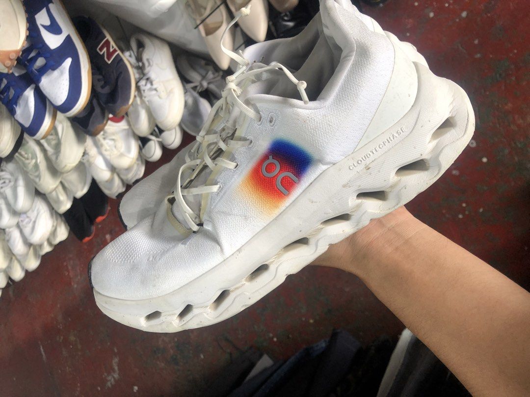 ON Cloudtilt White Running Shoes (Category: Sneakers) located in Cavite. Submitted by thriftkicks3 (Listing ID 1460993441, Image 3). Description: - ON Cloudtechphase running shoes - Color: White - Signature ON rainbow logo on the side - White laces - Chunky white soles with cutouts - Minor dirt marks present on fabric and soles - Suitable for running or casual wear.