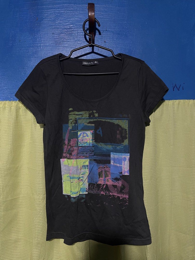 ONLY PLAY Black Graphic T-Shirt (Category: Blouses) located in Caloocan City. Submitted by jai_jai00 (Listing ID 1461054582, Image 1). Description: - Brand: ONLY PLAY - Color: Black - Design: Cool graphic print with abstract colorful squares and cityscapes - Neckline: Scoop neck - Sleeves: Short sleeves - Style: Comfortable, casual, great for everyday wear.