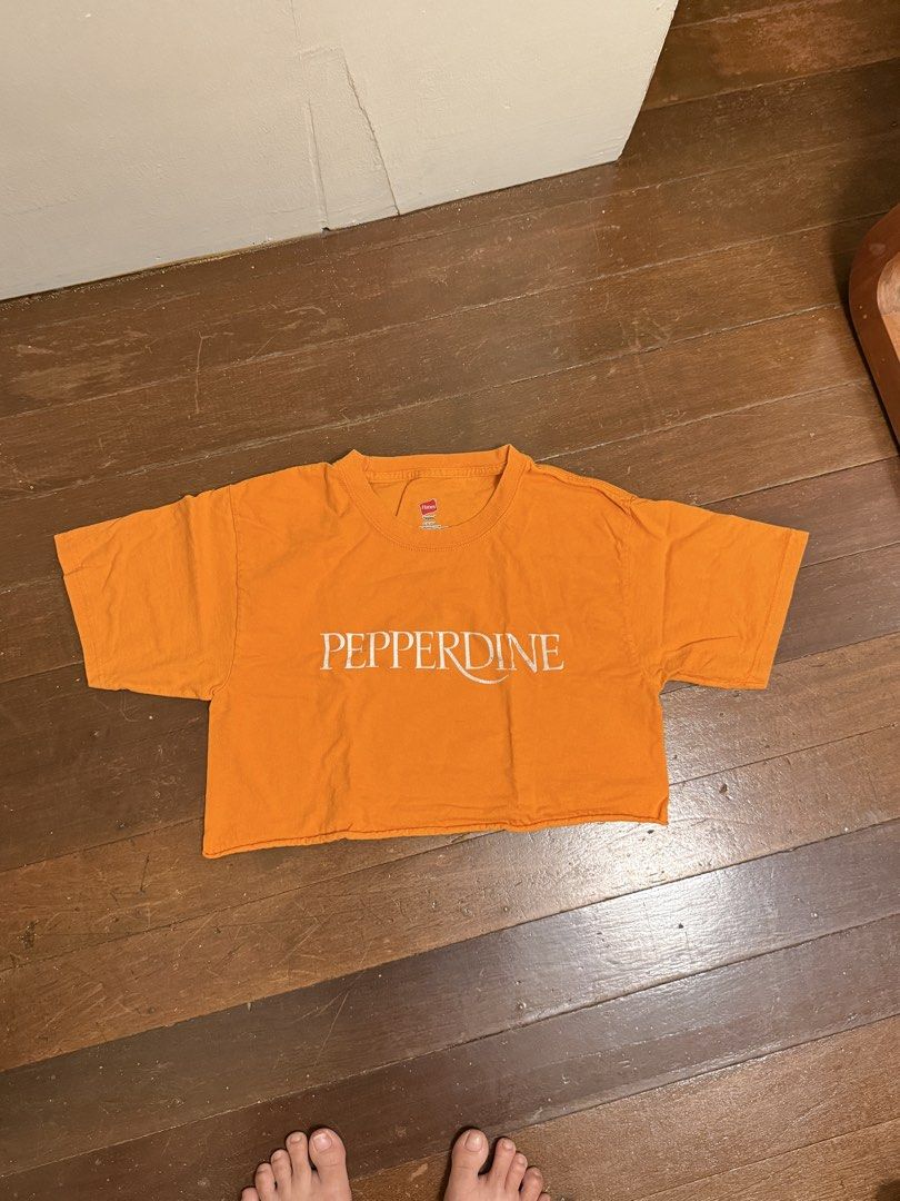 Orange Pepperdine Cropped T-Shirt (Category: Shirts) located in Angeles City. Submitted by lesmiz24601 (Listing ID 1460978307, Image 1). Description: - Orange cropped t-shirt - Features 'Pepperdine' graphic - Trendy raw hem detail - Short sleeves - Estimated size: Medium - Ideal for casual wear.