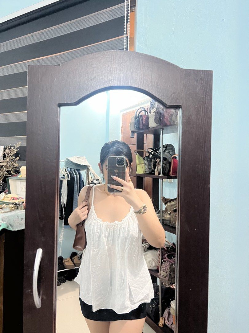 OVS White Spaghetti Strap Tank Top (Category: Sleeveless) located in Abucay. Submitted by pmuffy24 (Listing ID 1461102225, Image 2). Description: - White OVS tank top - Spaghetti straps with tie-back detail - Ruffled neckline - Lightweight fabric - Perfect for layering or wearing on its own - Easy to style.