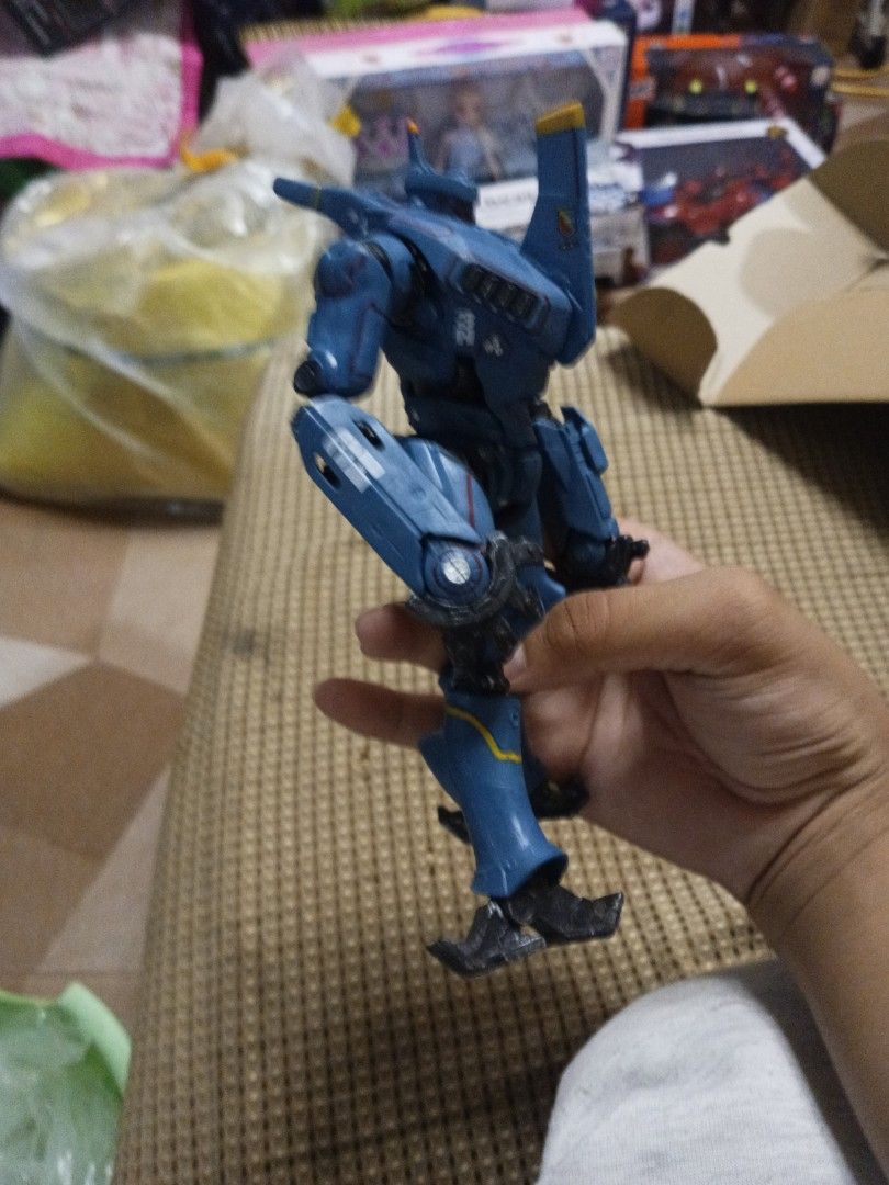 Pacific Rim Romeo Blue Action Figure (Category: Figurines & Statues) located in Tanza. Submitted by --unicorn-- (Listing ID 1461034627, Image 2). Description: - Romeo Blue action figure from Pacific Rim - Striking blue color with yellow accents - Fully articulated joints for dynamic posing - Ideal for fans of the movie - Minor scuffs present on the feet.
