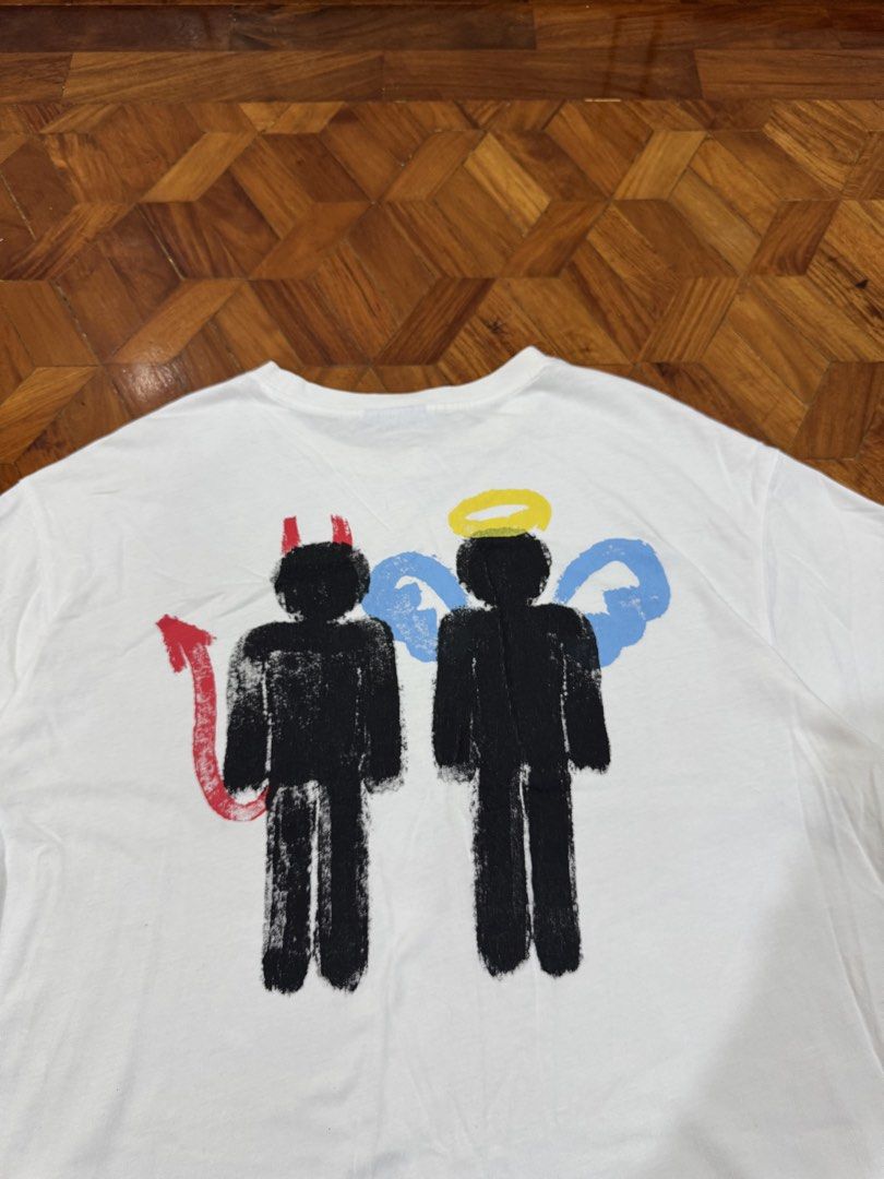 PEACH "Teach Peace" Graphic T-Shirt (Category: Tshirts & Polo Shirts ) located in Manila. Submitted by hypemeup.mla (Listing ID 1461089064, Image 3). Description: - White graphic t-shirt - "Teach Peace" design on the front - Devil and angel stick figure graphic on the back - Tag reads "PEACH" - Estimated size: Large (L) - Ideal for casual wear - 26x23 - excellent.