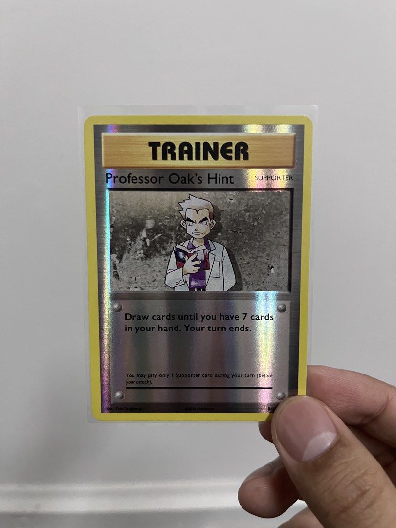 Pokemon Professor Oak's Hint Trainer Card (Category: Raw Singles) located in Pasay City. Submitted by paullimerized (Listing ID 1461052077, Image 1). Description: - Holographic Professor Oak's Hint Trainer card - Supporter card - Effect: Draw cards until you have 7 cards in your hand. Your turn ends. - Ideal for Pokémon TCG collectors!.