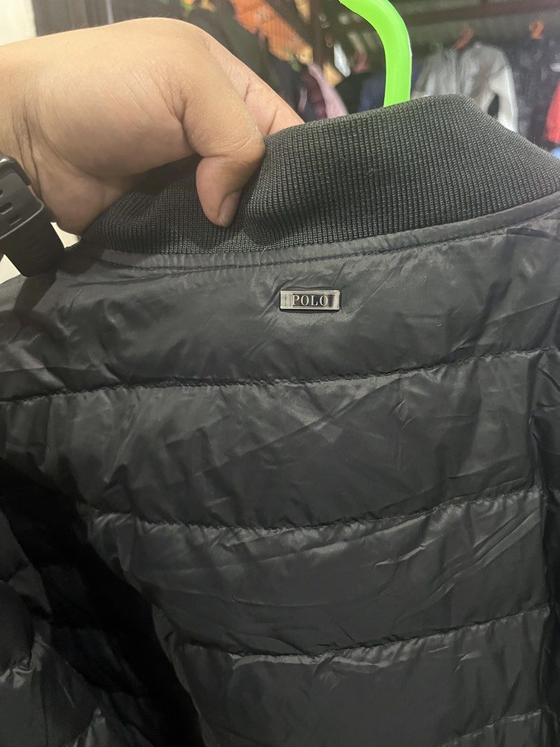 Polo Ralph Lauren Black Puffer Bomber Jacket (Category: Coats, Jackets and Outerwear) located in Tabuk. Submitted by collectors_thrift_shop (Listing ID 1461016849, Image 2). Description: - Polo puffer bomber jacket - Quilted design - Zip pockets - Ribbed collar and cuffs - Ideal for layering - Easy to pack and wear.