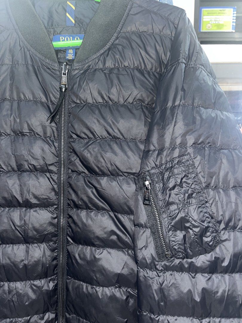 Polo Ralph Lauren Black Puffer Bomber Jacket (Category: Coats, Jackets and Outerwear) located in Tabuk. Submitted by collectors_thrift_shop (Listing ID 1461016849, Image 3). Description: - Polo puffer bomber jacket - Quilted design - Zip pockets - Ribbed collar and cuffs - Ideal for layering - Easy to pack and wear.