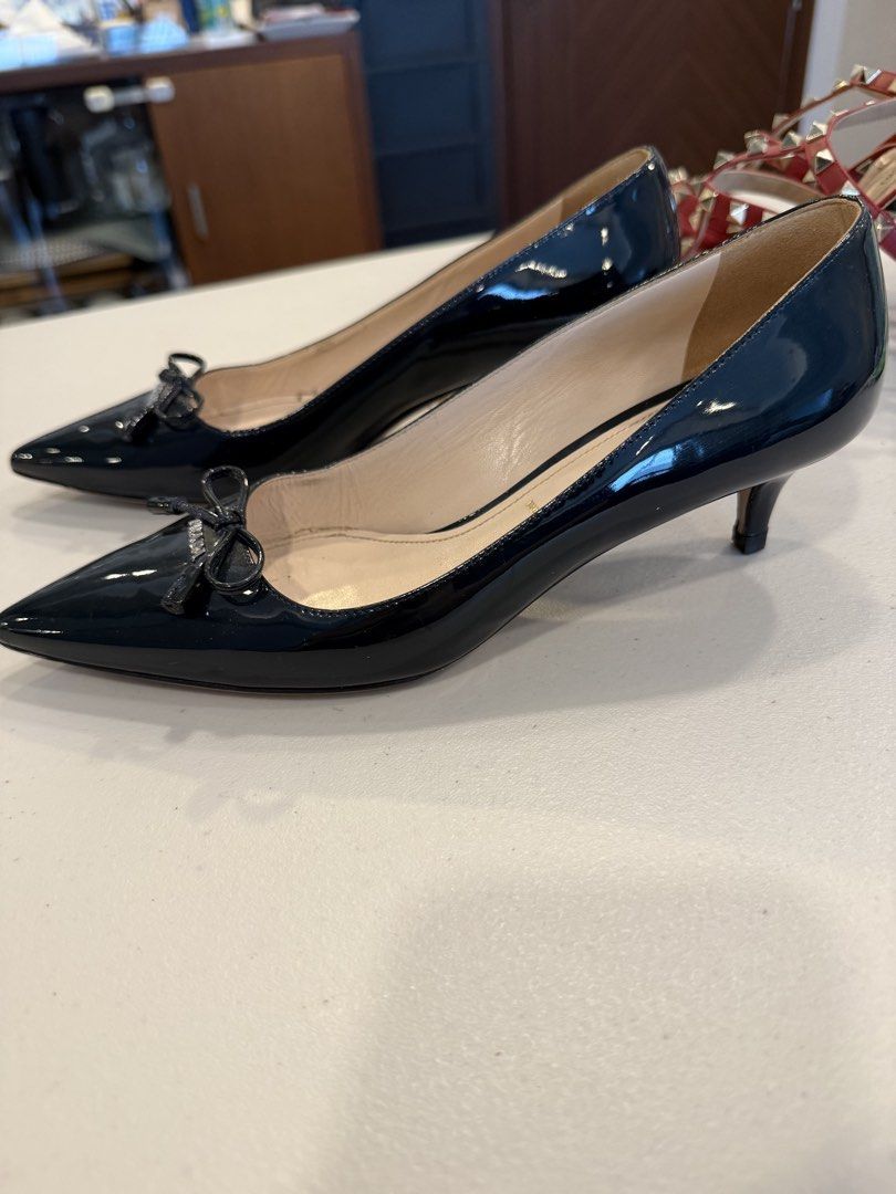 PRADA Black Patent Leather Bow Pumps — Size 37 (Category: Sneakers & Footwear) located in Pasig City. Submitted by marketplacesellinginc (Listing ID 1460995446, Image 2). Description: PRADA Black Patent Leather Bow Pumps — Size 37 Brand: Prada Size: 37 IT Made in: Italy Color: Black Material: Patent leather Style: Pointed-toe pumps with front bow and Prada logo detail Heel: Approximately 2 inches Condition: Pre-owned / Good condition * Beautiful 