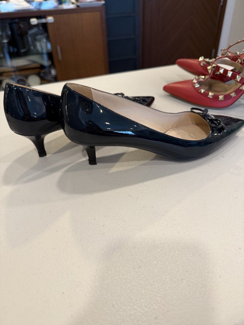 PRADA Black Patent Leather Bow Pumps — Size 37 (Category: Sneakers & Footwear) located in Pasig City. Submitted by marketplacesellinginc (Listing ID 1460995446, Image 3). Description: PRADA Black Patent Leather Bow Pumps — Size 37 Brand: Prada Size: 37 IT Made in: Italy Color: Black Material: Patent leather Style: Pointed-toe pumps with front bow and Prada logo detail Heel: Approximately 2 inches Condition: Pre-owned / Good condition * Beautiful 
