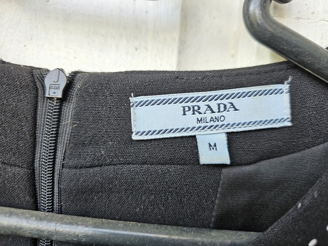 PRADA MILANO Black Dress Size M (Category: Dresses) located in Tagbilaran City. Submitted by lugarpogi (Listing ID 1460965170, Image 3). Description: - Brand: Prada - Size: M - Made in: Italy - Material: 70% Cotton, 30% Silk - Features: White contrast stitching on neckline, hem, and pockets - Closure: Back zipper - Style: Classic and chic.