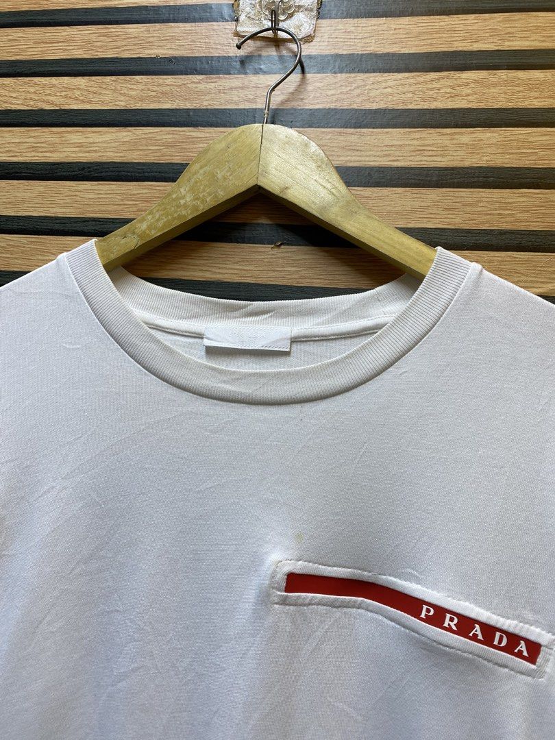 PRADA MILANO TEE (Category: Tshirts & Polo Shirts ) located in Makati City. Submitted by drip.poww (Listing ID 1461099916, Image 3). Description: - Authentic Prada milano - Color: White - Size: Large - Dimes: 22x29 - Authentic - Excellent condition - Need wash, fresh from bale - Material: 100% Cotton Please don’t expect too much—these are thrifted (ukay) items. 😊 !!STILL NEGOTIABLE!!.