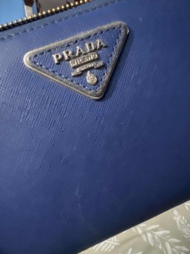 Prada Saffiano Leather Zip Around Wallet Blue (Category: Luxury Bags & Wallets) located in Lipa City. Submitted by wen_68 (Listing ID 1460986951, Image 2). Description: - Prada wallet - Blue saffiano leather - Zip around closure - Multiple card slots and compartments - Good overall condition - Minor dust inside from storage.