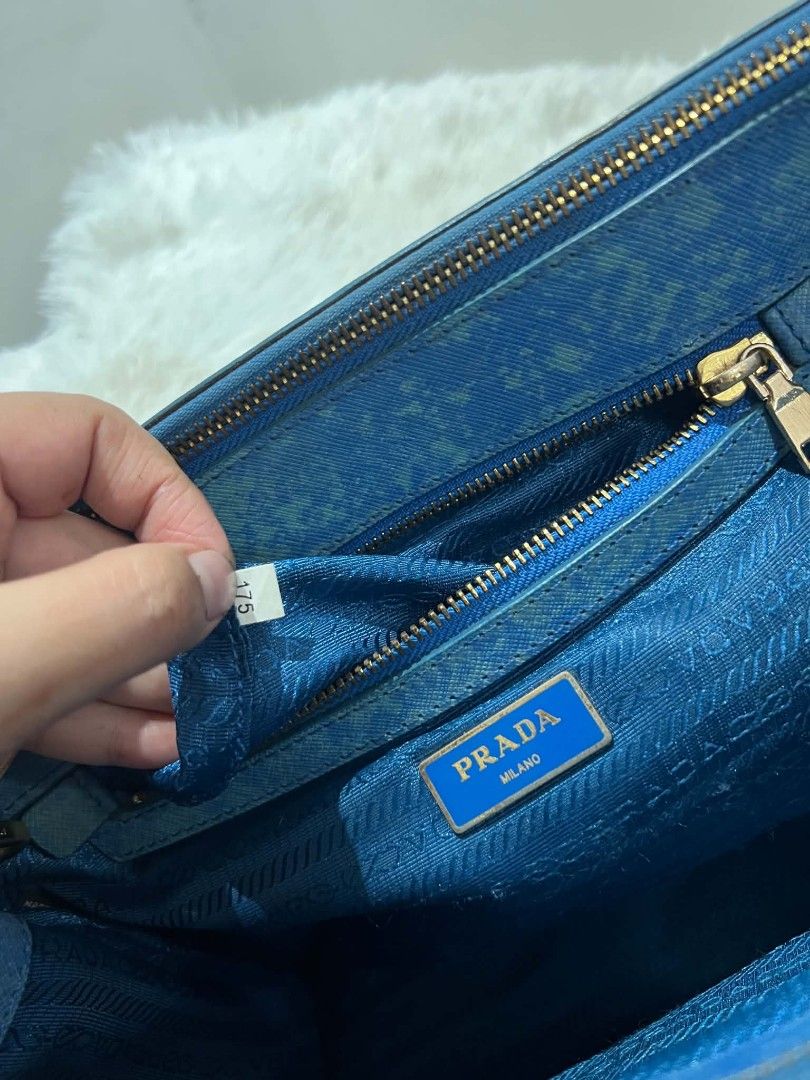 Prada Saffiano Lux Tote Bag Blue (Category: Luxury Bags & Wallets) located in Abucay. Submitted by chinithou (Listing ID 1460928086, Image 2). Description: - Prada bag - Color: Blue - Unique textured finish - Gold hardware details - Detachable shoulder strap included - Multiple interior compartments - Zippers and clasps in working condition - Versatile for everyday or special occasions.