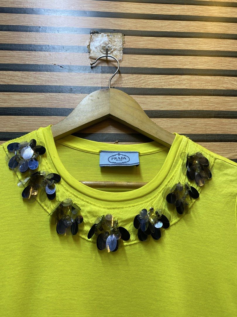 PRADA TEE (Category: Shirts) located in Makati City. Submitted by drip.poww (Listing ID 1461092326, Image 3). Description: - Authentic Prada milano - Color: Yellow - Size: Small - Dimes: 19x24 - Authentic - Excellent condition - Need wash, fresh from bale - Material: 100% Cotton Please don’t expect too much—these are thrifted (ukay) items. 😊 !!STILL NEGOTIABLE!!.