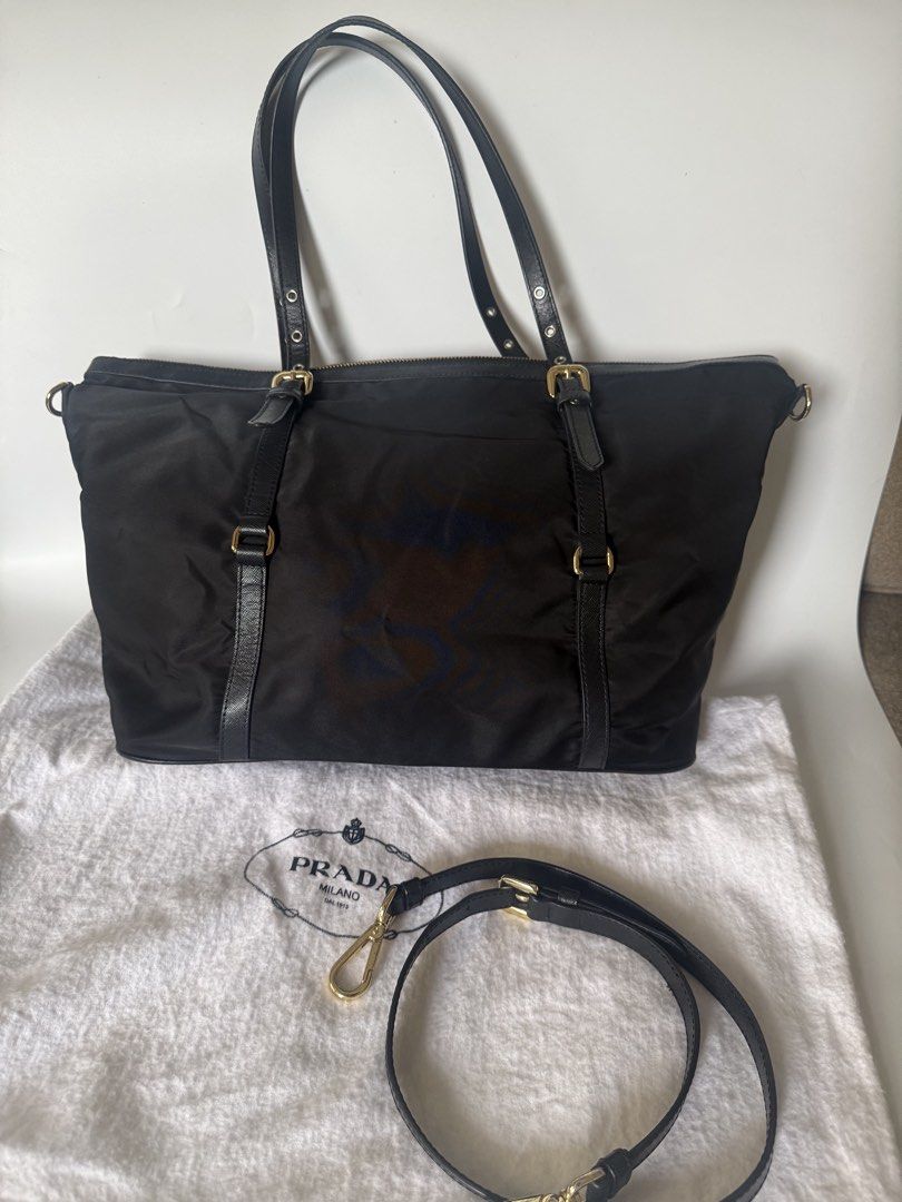 Prada Tessuto Nylon Tote Bag (Category: Luxury Bags & Wallets) located in Caloocan City. Submitted by krishazach (Listing ID 1461115170, Image 2). Description: - Authentic Prada tote bag - Color: Black nylon with black leather accents - Hardware: Gold - Features: Detachable shoulder strap, dust bag included - Interior: Spacious, ideal for daily essentials - Closure: Top zip Includes : Dust bag only Authentic 💯 See photos for issues 7/10.