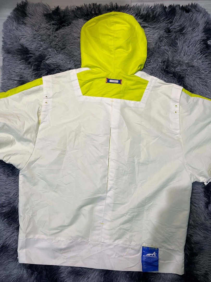 Puma x ADER Error White Neon Windbreaker Jacket (Category: Coats, Jackets and Outerwear) located in Manila. Submitted by yanggoonz (Listing ID 1461041358, Image 3). Description: Authentic - Puma x ADER Error collaboration windbreaker - Color: White with neon yellow accents - Style: Quarter zip pullover with hood - Features: Large front pocket - Perfect for: Layering or standalone streetwear look.