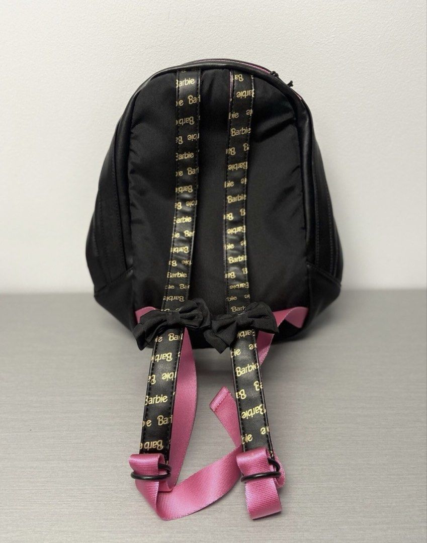 Puma x Barbie Black Suede Backpack (Category: Backpacks) located in Lapu Lapu. Submitted by cecillia07 (Listing ID 1461035907, Image 3). Description: - Black Puma backpack with exclusive Barbie collaboration details. - Features a stylish suede front panel and elegant faux leather accents. - Vibrant bright pink interior lining for a pop of color. - Adjustable straps adorned with Barbie branding and charming bow details. - Includes a convenient fro