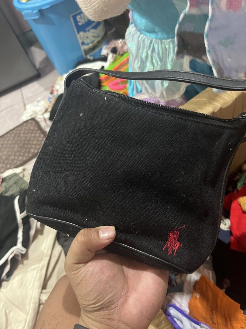 Ralph Lauren Black Canvas Mini Shoulder Bag (Category: Luxury Bags & Wallets) located in Tabuk. Submitted by collectors_thrift_shop (Listing ID 1461017439, Image 1). Description: - Cute black canvas shoulder bag from Ralph Lauren - Features the iconic red polo player logo - Small size, perfect for carrying essentials - Secure zipper closure - Interior slip pocket for organization - Adjustable strap for comfortable wear - Great for casual outings 