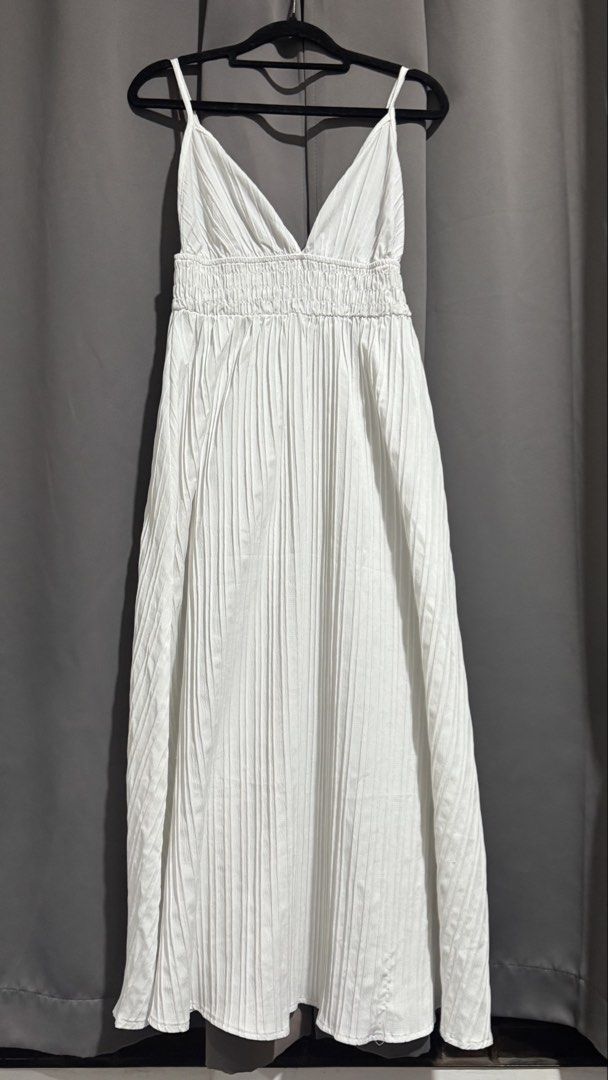 Random dresses (Category: Dresses) located in Manila. Submitted by ainanicole82544 (Listing ID 1461105853, Image 3). Description: - Elegant white maxi dress - Deep V-neckline - Comfortable smocked bodice - Full pleated skirt - Delicate spaghetti straps - Ideal for summer occasions - Versatile for dressing up or down.