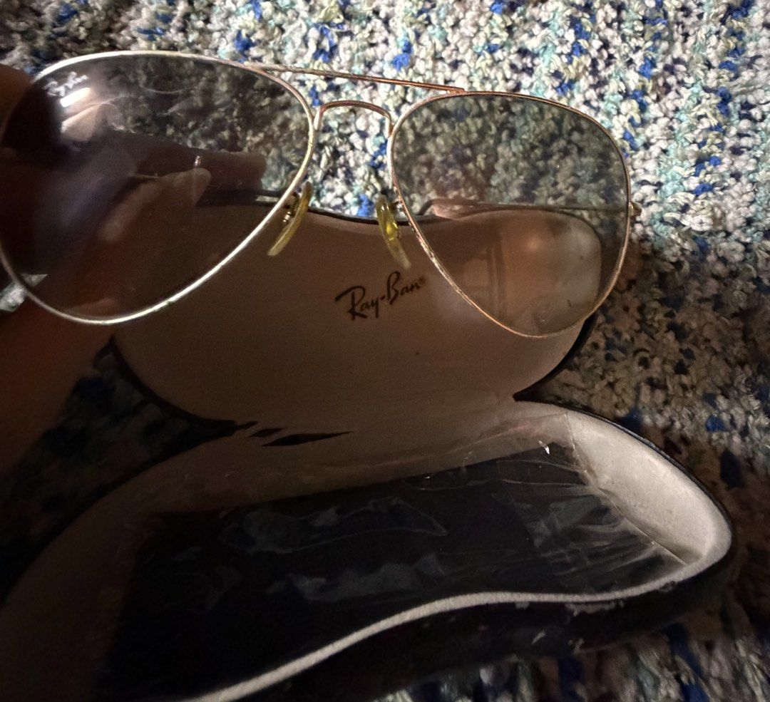 Ray-Ban Aviator Sunglasses with Case (Category: Sunglasses & Eyewear) located in Quezon City. Submitted by jhosa888 (Listing ID 1461051531, Image 1). Description: - Classic Ray-Ban aviator sunglasses - Gold frame with tinted lenses - Includes original Ray-Ban hard case - Perfect for sunny days - Lenses have some smudges - Case shows some wear inside.