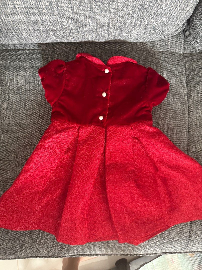 Red Baby Formal Dress - Periwinkle (Category: Babies & Kids Fashion) located in Las Pinas. Submitted by whistlesnowbells (Listing ID 1460965513, Image 3). Description: Used once for an occasion Brand: Periwinkle - Size: 6 months. - Dress features a luxurious velvet top and a brocade skirt with a subtle pattern. - Elegant Peter Pan collar and a sweet bow detail at the waist. - Convenient closure with small pearl buttons at the back. - Ideal for pa