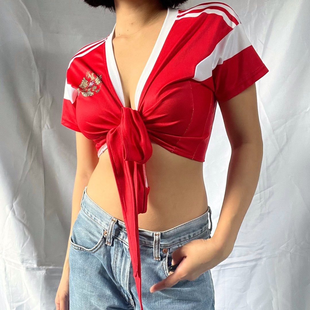 Red Tie-Front Crop Top with White Stripes (Category: Blouses) located in Manila. Submitted by demi.rewears (Listing ID 1460926835, Image 1). Description: Cute red tie-front crop top with white stripes and chest emblem. Adjustable tie front. Perfect for a casual, sporty look with jeans or shorts. Bust: 16” (Flat) / Fits up to 32” Bust Length: 15” Style: Tie-Front / Front-Knot Crop Top Neckline: Deep V-Neck Details: Athletic shoulder striping & cre