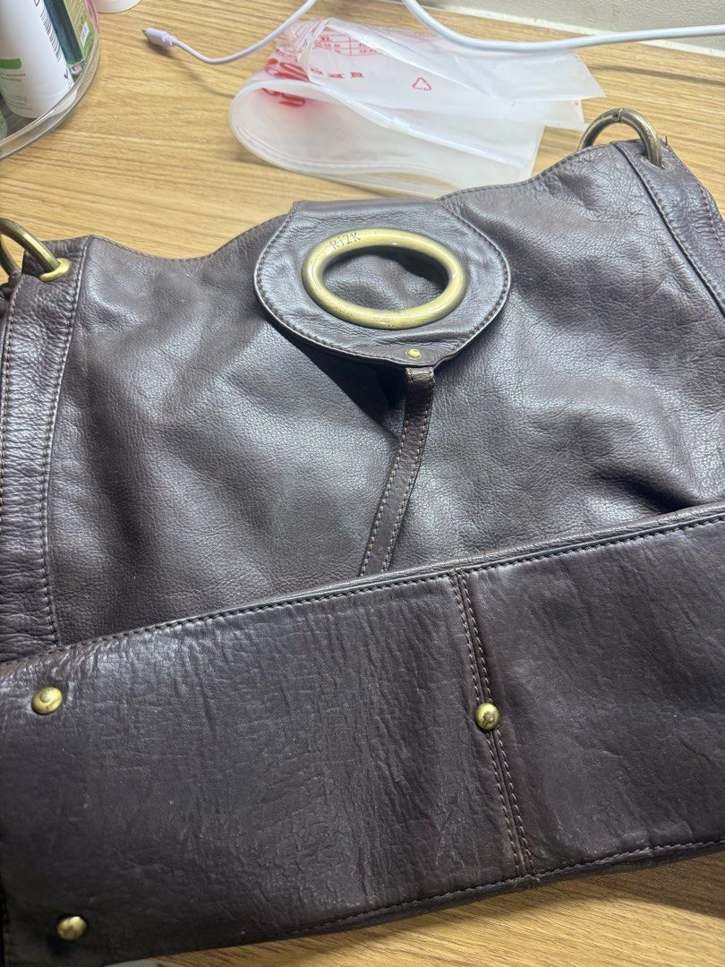 RI2K London Brown Leather Shoulder Bag (Category: Shoulder Bags) located in Manila. Submitted by lilag (Listing ID 1461035992, Image 1). Description: - Brand: RI2K London - Material: Brown Leather - Closure: Flap with circular metal detail - Interior: 1 zippered pocket, 1 slip pocket - Features: Textured leather finish - Style: Great everyday shoulder bag.