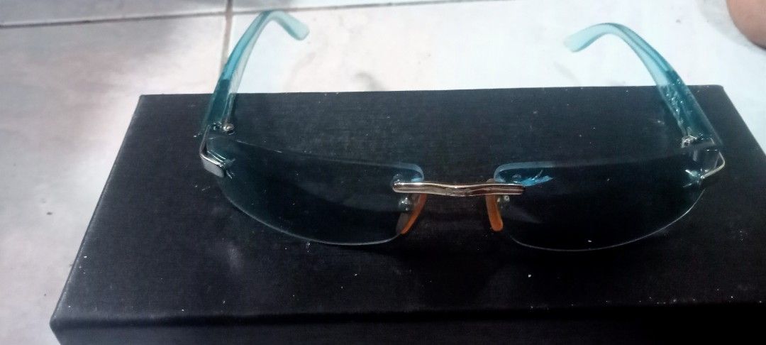 Rimless Blue Tinted Sunglasses (Category: Sunglasses & Eyewear) located in Paranaque City. Submitted by dimaguilaa94969 (Listing ID 1460960987, Image 1). Description: - Rimless sunglasses - Light blue frames - Blue tinted lenses - Sleek, modern design09260966619 - Perfect for sunny days - Comes with a black case.