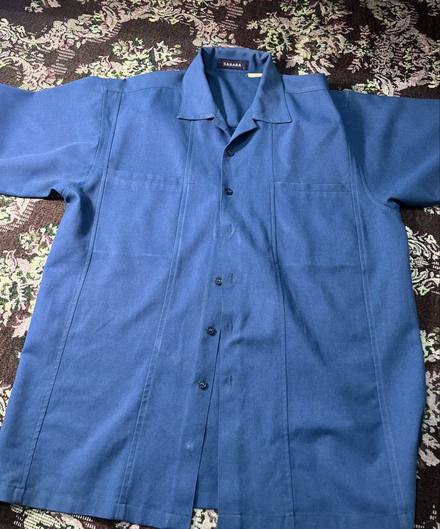 Sahara Blue Short Sleeve Button Up Shirt (Category: Tshirts & Polo Shirts ) located in Manila. Submitted by sennisen (Listing ID 1461094512, Image 1). Description: - Sahara brand blue short sleeve shirt - Features a collar and button-up front - Two chest pockets for convenience - Relaxed fit for comfortable, casual wear.