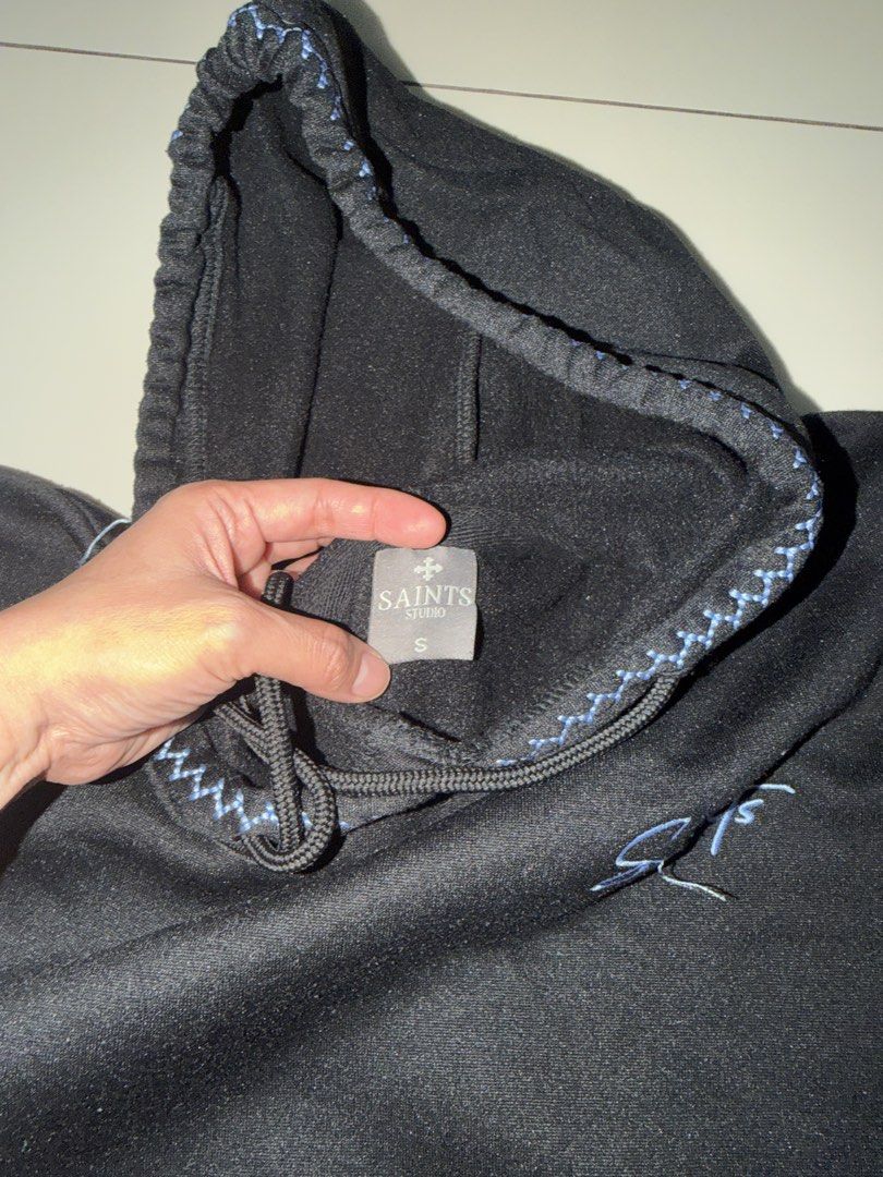 Saints Studio Black Hoodie Size S (Category: Hoodies) located in Rizal. Submitted by macristina33105 (Listing ID 1461031568, Image 2). Description: - Saints Studio Black Hoodie - Size: S - Contrast stitching on hood, sleeves, and pocket - Simple logo on chest - Comfortable and stylish design.
