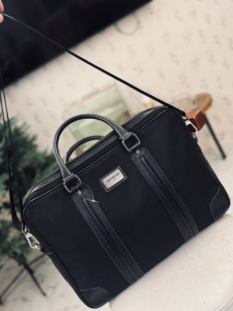 Samsonite Black Business Briefcase Bag (Category: Briefcases) located in Bacolod City. Submitted by vintage_vogue6100 (Listing ID 1461070666, Image 3). Description: - Classic black briefcase - Durable material with leather accents - Features top handles and a detachable shoulder strap - Offers plenty of space for your work essentials - Ideal for daily commutes and business trips.