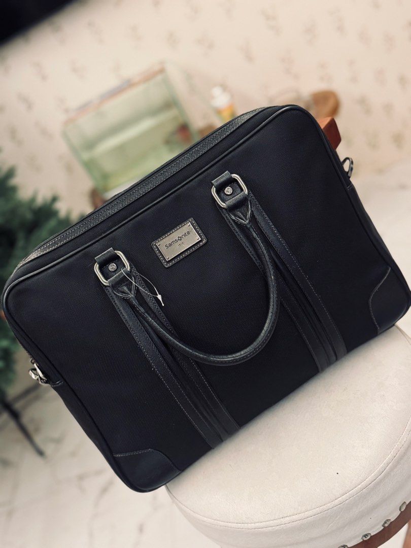 Samsonite Black Business Briefcase Bag (Category: Briefcases) located in Bacolod City. Submitted by vintage_vogue6100 (Listing ID 1461070666, Image 1). Description: - Classic black briefcase - Durable material with leather accents - Features top handles and a detachable shoulder strap - Offers plenty of space for your work essentials - Ideal for daily commutes and business trips.