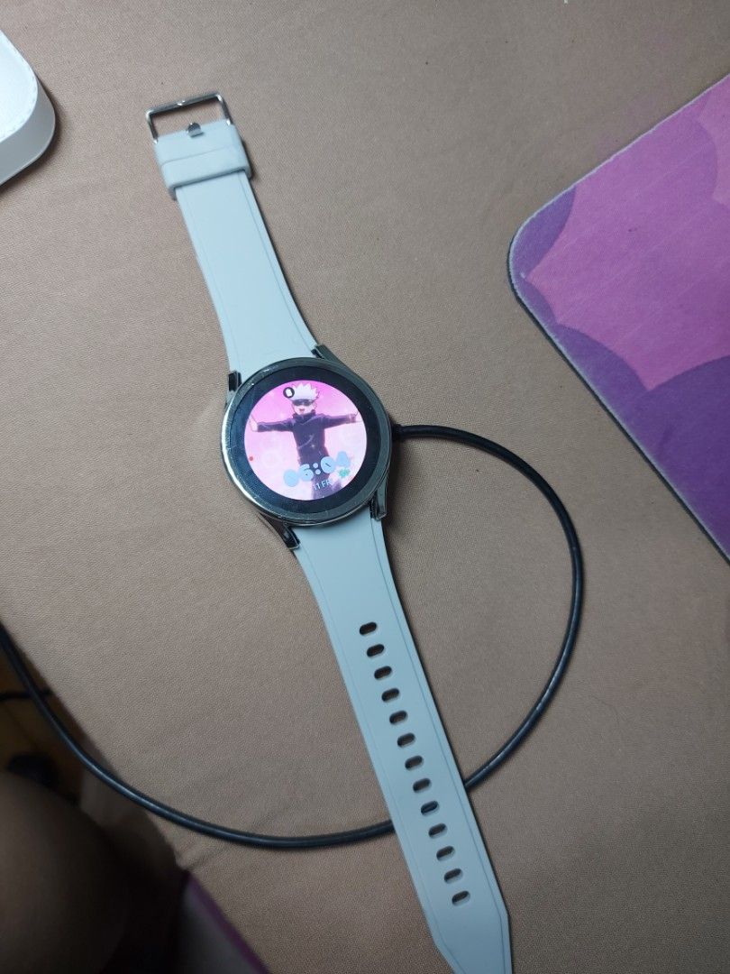 Samsung Galaxy Watch 4 40mm Smartwatch (Category: Wearables & Smart Watches) located in Manila. Submitted by nicolezald25729 (Listing ID 1461018735, Image 1). Description: - Samsung Galaxy Watch 4 - 40mm size - Includes original light grey strap - Currently charging, displaying a cute animated watch face - Back shows model details and charging port -Inclusions: Watch Accesories and chord charger only Loc: Parañaque.