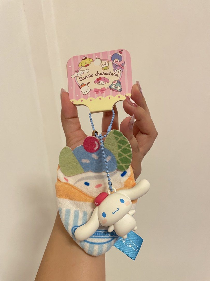 Sanrio Cinnamoroll Cupcake Plush Keychain (Category: Plushies & Soft Toys) located in Iba. Submitted by wealtheallymari99 (Listing ID 1461084452, Image 2). Description: - Adorable Cinnamoroll plush keychain designed as a cupcake. - Features Cinnamoroll peeking out from the top. - Comes with a stylish blue beaded chain. - Includes a cute blue ribbon tag. - Perfect for personalizing bags, backpacks, and more. - Authentic Sanrio merchandise..