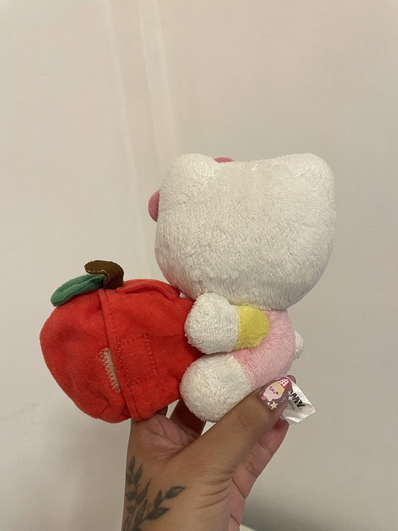 Sanrio Hello Kitty Plush with Apple (Category: Plushies & Soft Toys) located in Iba. Submitted by wealtheallymari99 (Listing ID 1461085268, Image 2). Description: - Adorable Kitty plush toy - Comes with a red apple featuring 'KT' embroidery - Authentic Sanrio product - Ideal for Kitty collectors - Makes a wonderful gift - Small and huggable size.