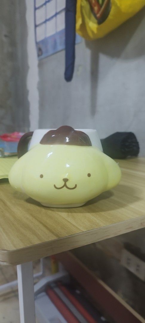 Sanrio Pompompurin Mug (Category: Coffee & Tea Tableware) located in Manila. Submitted by silverwhale_cafa21 (Listing ID 1461038561, Image 1). Description: - Adorable Pompompurin mug in signature yellow. - Features his iconic pudding hat design. - Ideal for enjoying your morning coffee or tea. - A must-have for any Sanrio enthusiast. - Adds a fun and cheerful touch to your kitchenware collection..