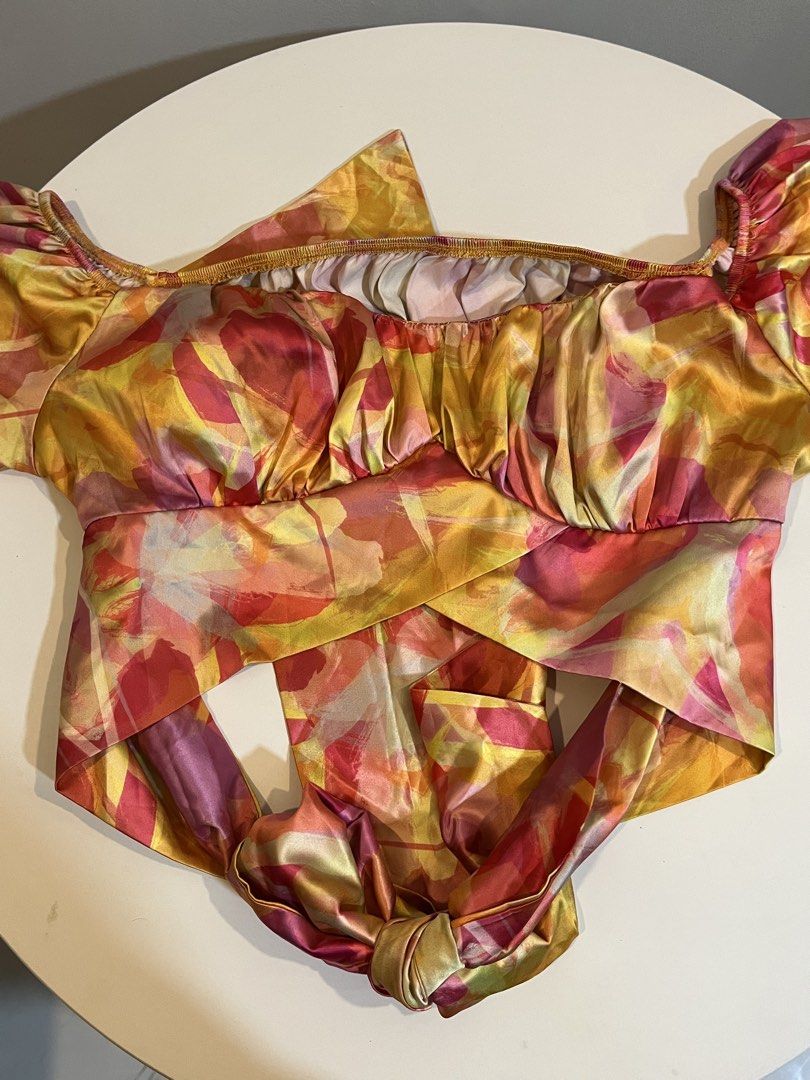 Satin Abstract Print Off-Shoulder Crop Top (Category: Others Tops) located in Manila. Submitted by xoshushi.dcltr (Listing ID 1460974658, Image 2). Description: - Super cute satin crop top - Vibrant abstract print - Off-shoulder neckline - Long puff sleeves with elasticated cuffs - Wrap-around tie detail in front - Ideal for night outs or special occasions - Pairs well with high-waisted bottoms.
