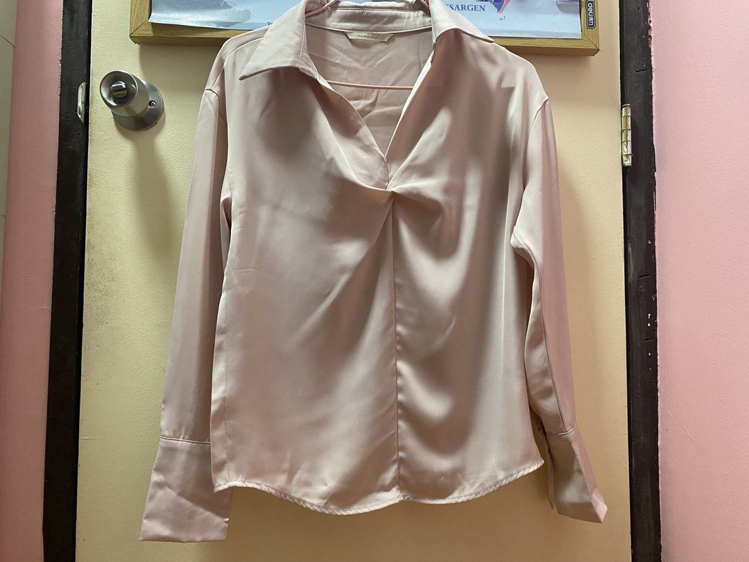 Satin Twist Front Collared Long Sleeve Blouse (Category: Blouses) located in Quezon City. Submitted by jeseym.23 (Listing ID 1461050657, Image 1). Description: - Light pink satin blouse - Twist detail at neckline - Collared design - Long sleeves with button cuffs - Loose type when worn - Versatile for dressing up or down - Comfortable and stylish.