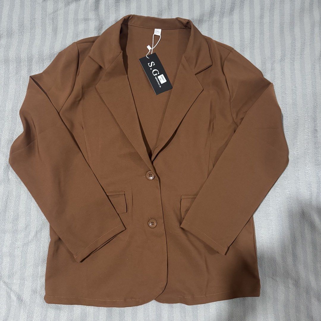 S.G. Brown Two-Button Blazer (Category: Coats, Jackets and Outerwear) located in Manila. Submitted by ainanicole82544 (Listing ID 1461104902, Image 1). Description: Fits xl - Brand new brown blazer - Size: 3XL - Two-button front closure - Two front pockets - Tag still attached - Ideal for dressing up any outfit.