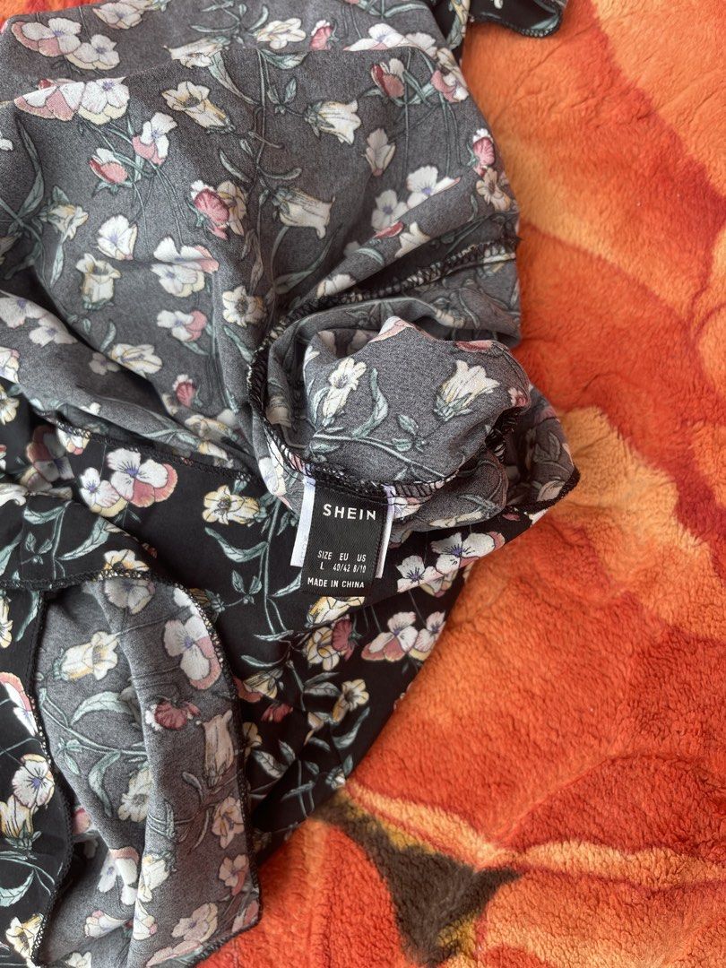 SHEIN Black Floral Bell Sleeve Romper (Category: Rompers) located in Manila. Submitted by aikyy_ (Listing ID 1460922447, Image 3). Description: - Cute black romper with a lovely floral print. - Features stylish bell sleeves and a flattering V-neck. - Elasticated waist ensures a comfortable and adjustable fit. - Perfect for casual outings or evenings with friends. - Brand: SHEIN - Measurements are available in the product photos..