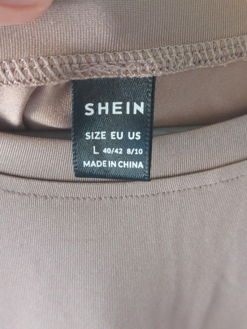 SHEIN Brown T-shirt (Category: Tshirts & Polo Shirts ) located in Malaybalay. Submitted by mags_sofia (Listing ID 1461014093, Image 3). Description: - Color: Brownish-taupe - Graphic: White 'freedom' print (vertical) - Neckline: Crew neck - Sleeves: Short sleeves - Fabric: Soft, slightly textured - Size: L - Style: Casual wear.