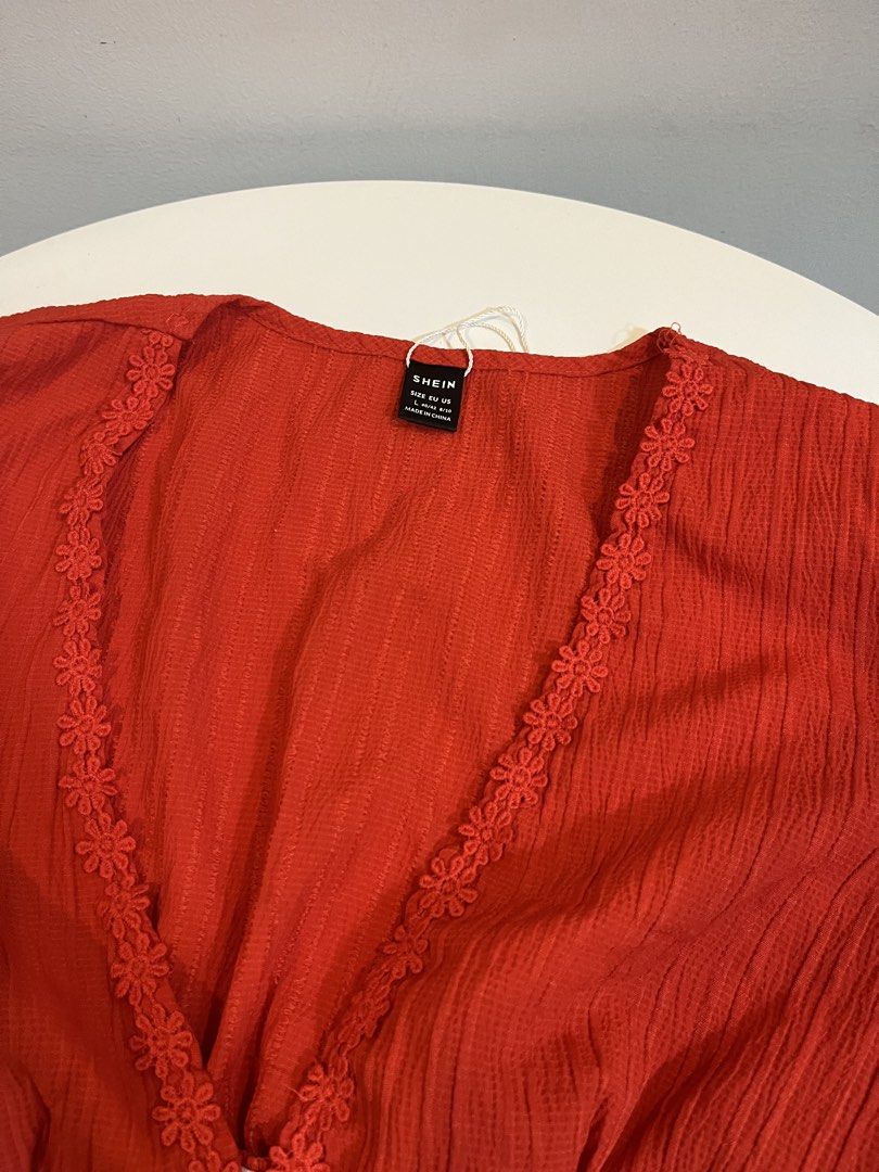SHEIN Red Button Front Cropped Top with Lace Trim (Category: Blouses) located in Manila. Submitted by xoshushi.dcltr (Listing ID 1460976702, Image 2). Description: - Red cropped top from SHEIN - Size: L - V-neck with floral lace trim - Button-up front - Puff sleeves - Textured fabric - Versatile for casual or dressed-up looks.