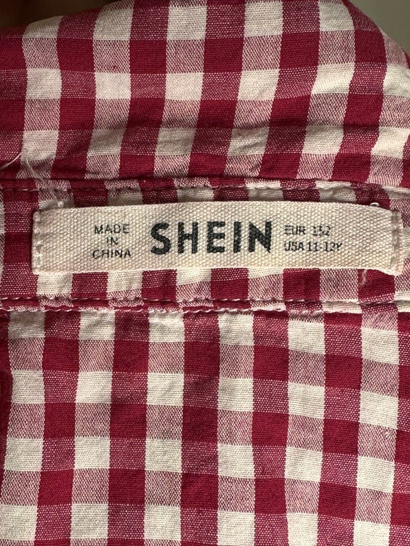 SHEIN Red Gingham Tie-Front Button-Up Shirt Top (Category: Blouses) located in Balanga. Submitted by amberinesis (Listing ID 1460942360, Image 2). Description: - Cute red and white gingham pattern - Tie-front design - Sleeveless with ruffled cap sleeves - Button-up front - Brand: SHEIN - Perfect for a casual summer outfit.