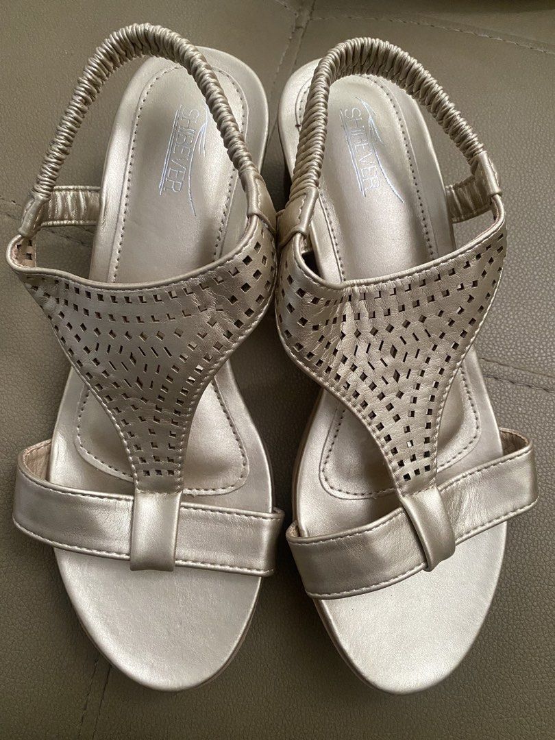 Shibever Gold Wedge Sandals with Elastic Straps (Category: Wedges) located in Balanga. Submitted by thebrownbagcompany (Listing ID 1460972819, Image 1). Description: - Gold wedge sandals by Shibever - Features a cute laser-cut design on the front straps - Comfortable elastic slingback strap - Versatile: great for dressing up or down - Easy slip-on and off design.