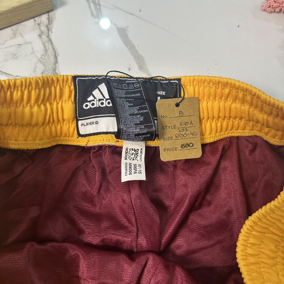 Shortpants (Category: Men's Grooming) located in Baguio. Submitted by kayeonlineshop (Listing ID 1460984258, Image 3). Description: maroon Adidas Cleveland Cavaliers basketball shorts featuring a bright yellow waistband and the team's signature sword logo on the leg NBA L32 W30-40 leghole 27.5.