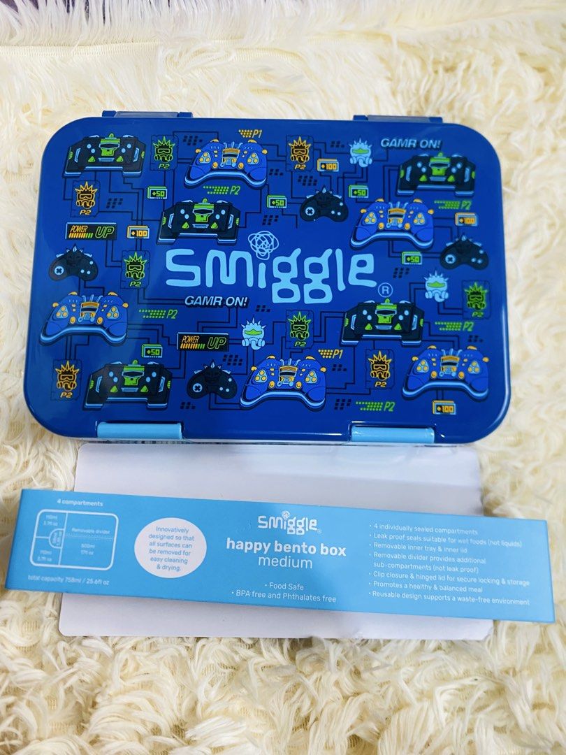 Smiggle Happy Bento Box Medium - Various Designs (Category: Food Organization & Storage) located in Manila. Submitted by mariamicaella24 (Listing ID 1461094571, Image 2). Description: - Smiggle Happy Bento Box (Medium Size) - Available in cute designs: Bunnies, Gaming Controllers, Princesses, Dinosaurs - Features 4 compartments - Includes a removable divider for customization - Ideal for packing healthy and fun lunches - Made from BPA and phthala