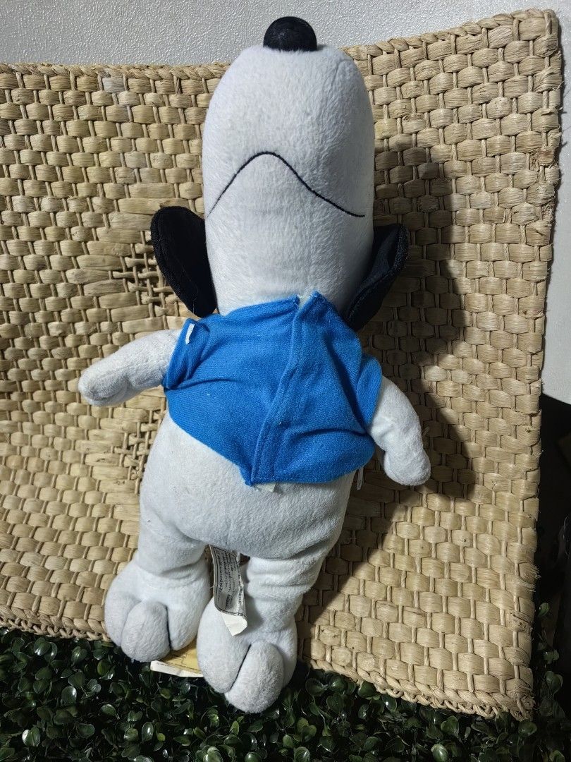 Snoopy Sleeping Body Pillow Plush 15inches (Category: Plushies & Soft Toys) located in Calamba. Submitted by princesspauliney. (Listing ID 1461083068, Image 3). Description: Snoopy lying on his stomach in a flat napping posture, sporting a distinctive blue t-shirt or collar. It is widely used as a compact napping companion or decorative bedding accent. Calamba laguna Shoppee check out.