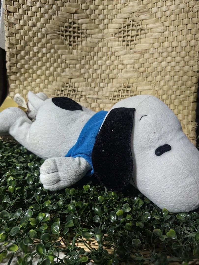 Snoopy Sleeping Body Pillow Plush 15inches (Category: Plushies & Soft Toys) located in Calamba. Submitted by princesspauliney. (Listing ID 1461083068, Image 1). Description: Snoopy lying on his stomach in a flat napping posture, sporting a distinctive blue t-shirt or collar. It is widely used as a compact napping companion or decorative bedding accent. Calamba laguna Shoppee check out.