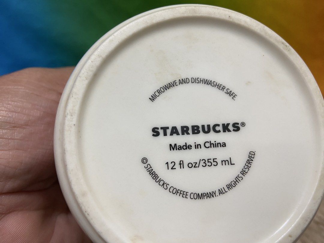 Starbucks White Mug 12oz (Category: Coffee & Tea Tableware) located in Pasig City. Submitted by jie_russ (Listing ID 1460959147, Image 2). Description: - Classic white Starbucks mug - Features the iconic siren logo - Capacity: 12oz (355mL) - Microwave and dishwasher safe - Ideal for your morning coffee or tea.